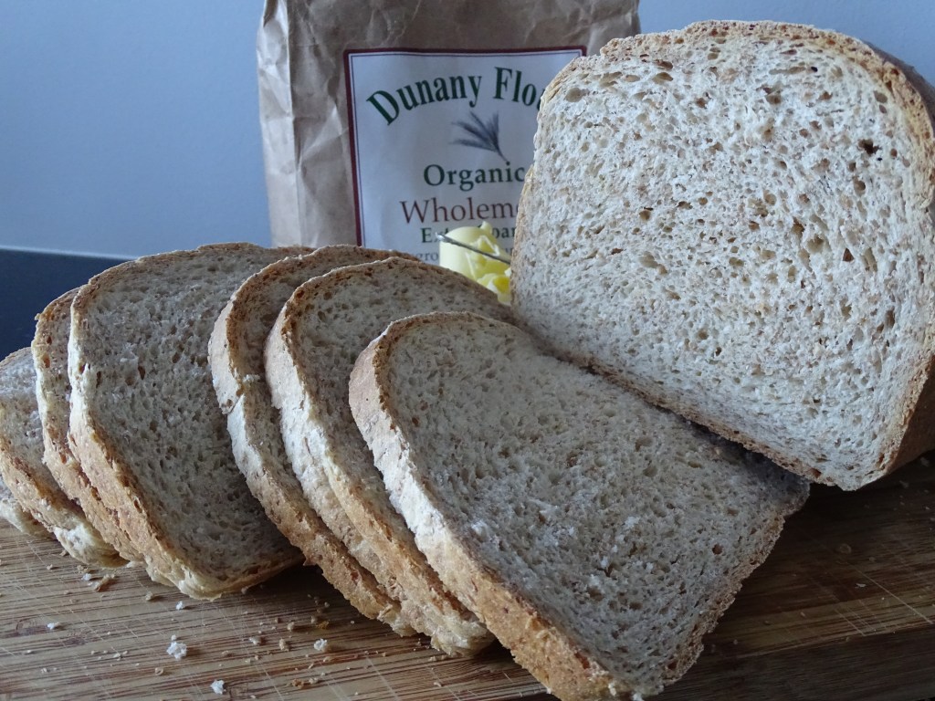 slices of wholemeal bread, bag of flour, chopping board