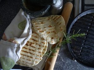 Flatbreads, griddle pan, rolling pin , rosemary sprig, pestle & morter