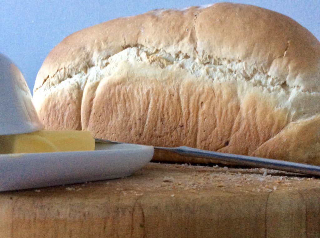 full white loaf, knife, butter, chopping board