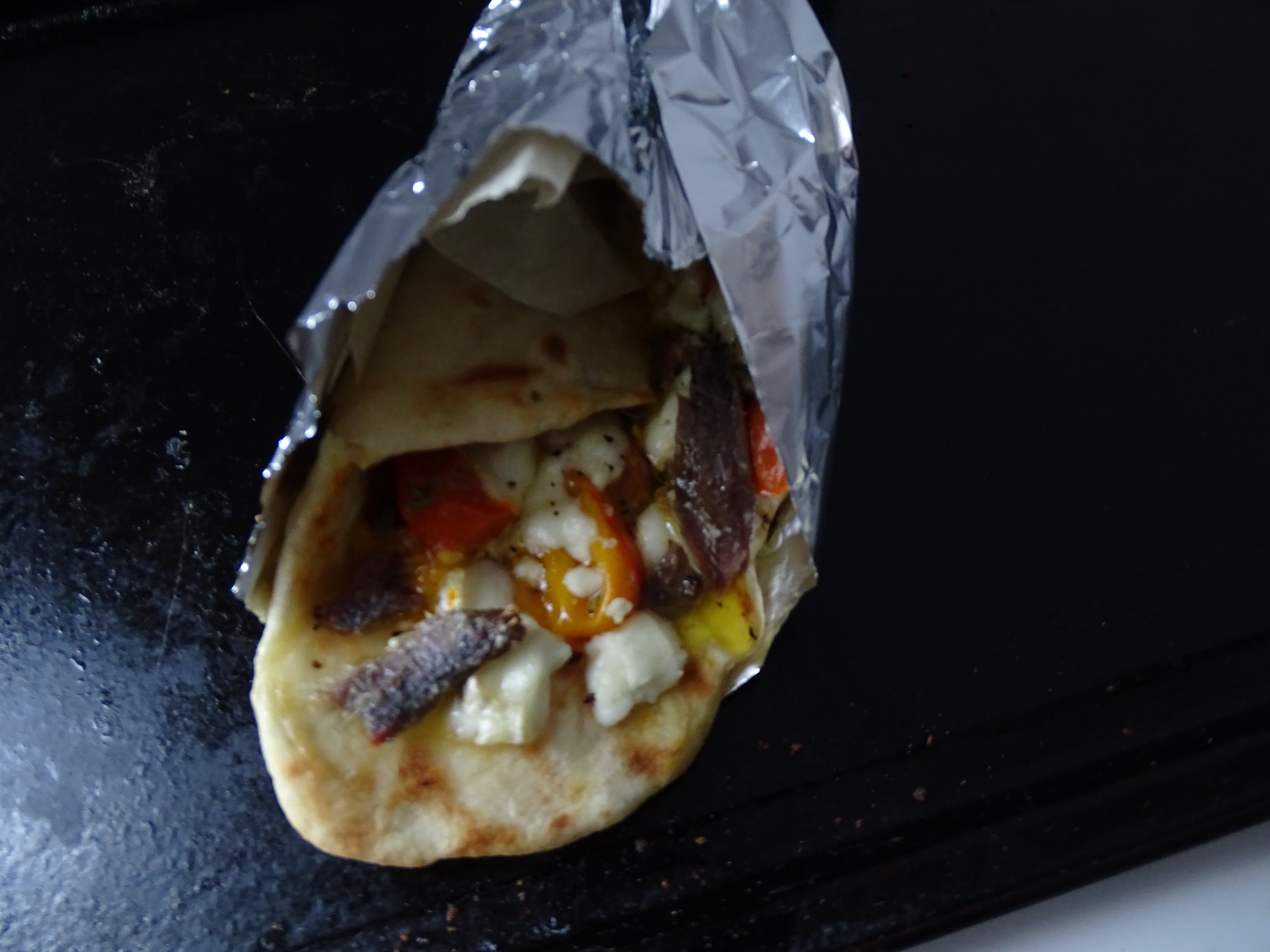 flatbread wrap, goats cheese, cherry tomatoes, anchovies
