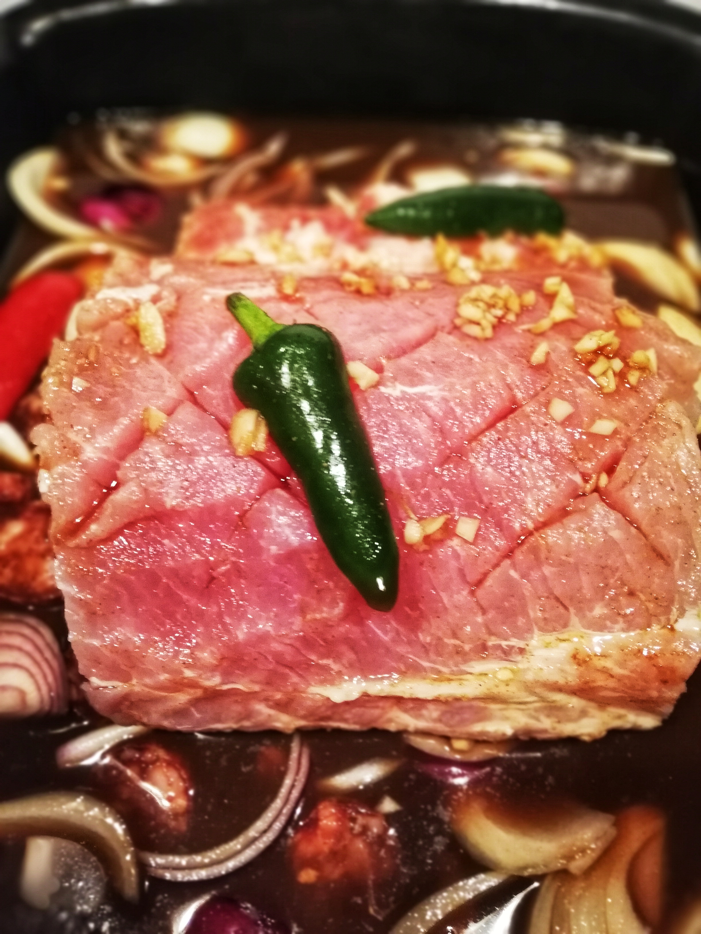 Marinaded bacon loin before heading into the oven