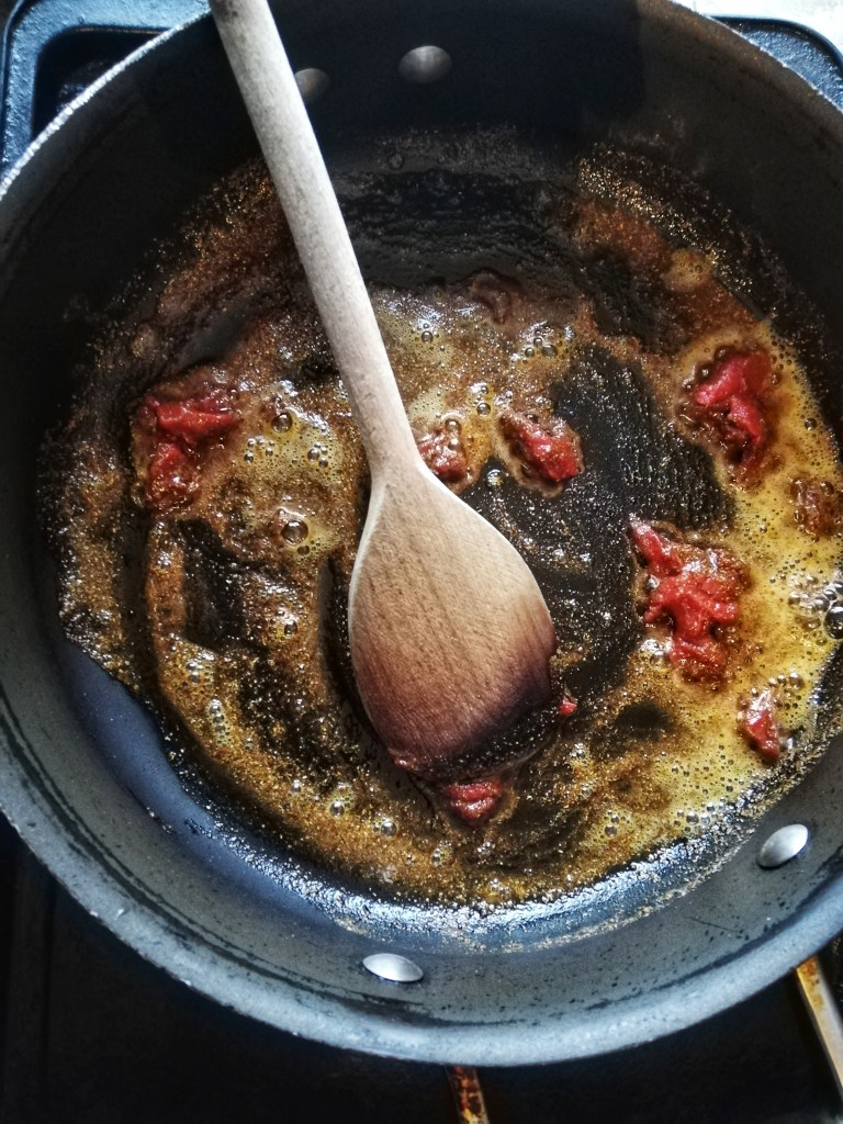 Tempering the spices for the chilli