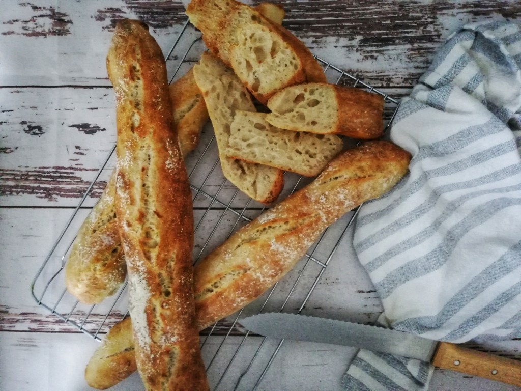 Sourdough baguettes, knife,tea towel