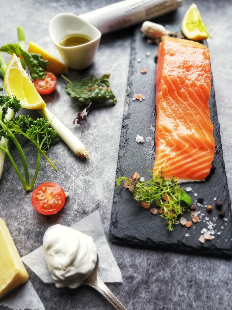 Salmon fillet on slate to parsley sprigs, lemons,