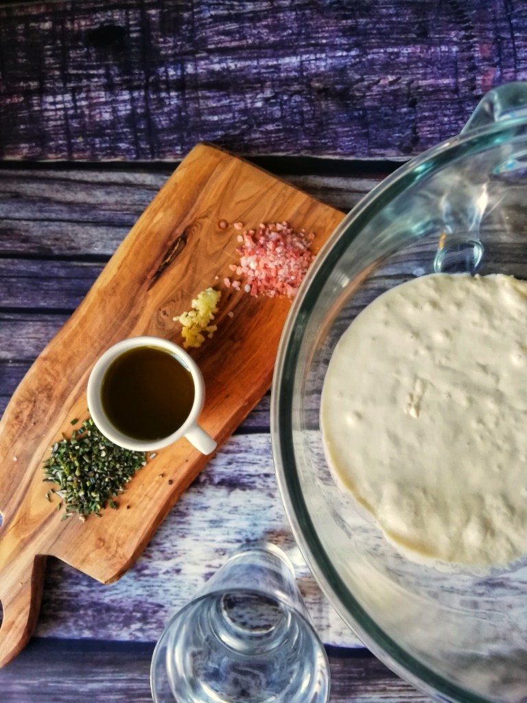 Food photography,Dough fermenting, chopped rosemary,garlic,olive oil, seasalt