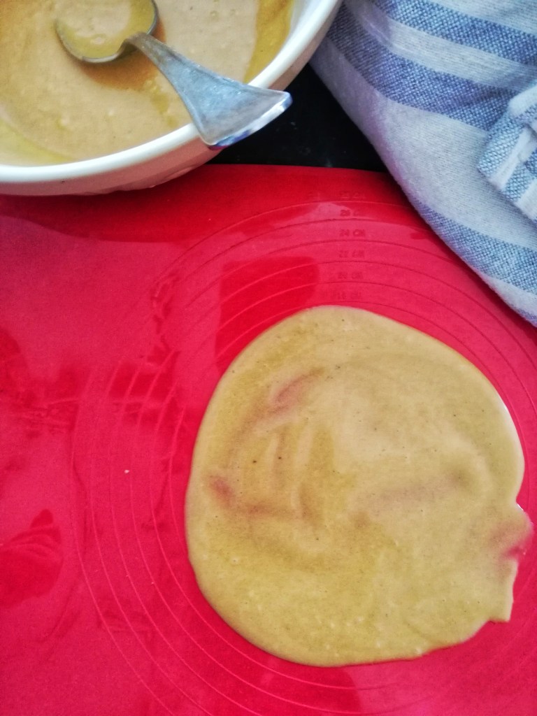 Spreading sugar cone mix onto silicone mat