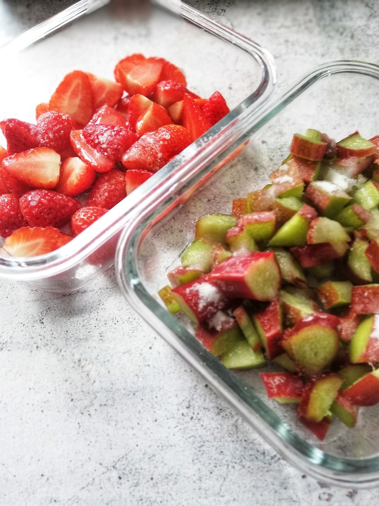 Prepping the strawberries and rhubarb for the sorbet, two glass dishes.
