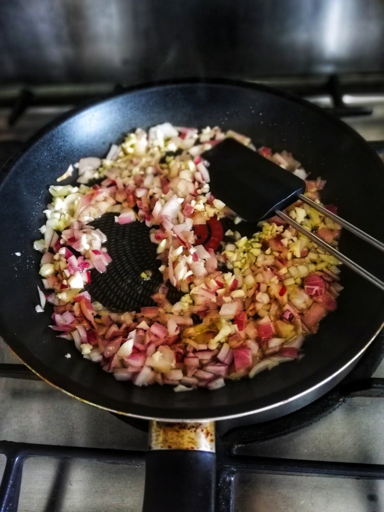 Sauteing onion and garlic in frying pan