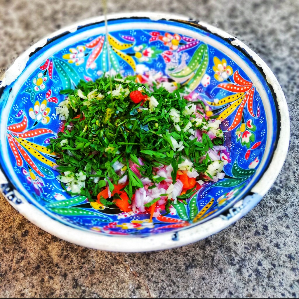 Chopped ingredients for homemade dressing in colourful bowl