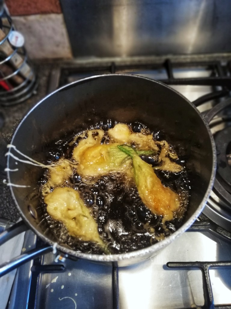 Food photography,Frying the tempura squash blossoms, oil, sauce pan