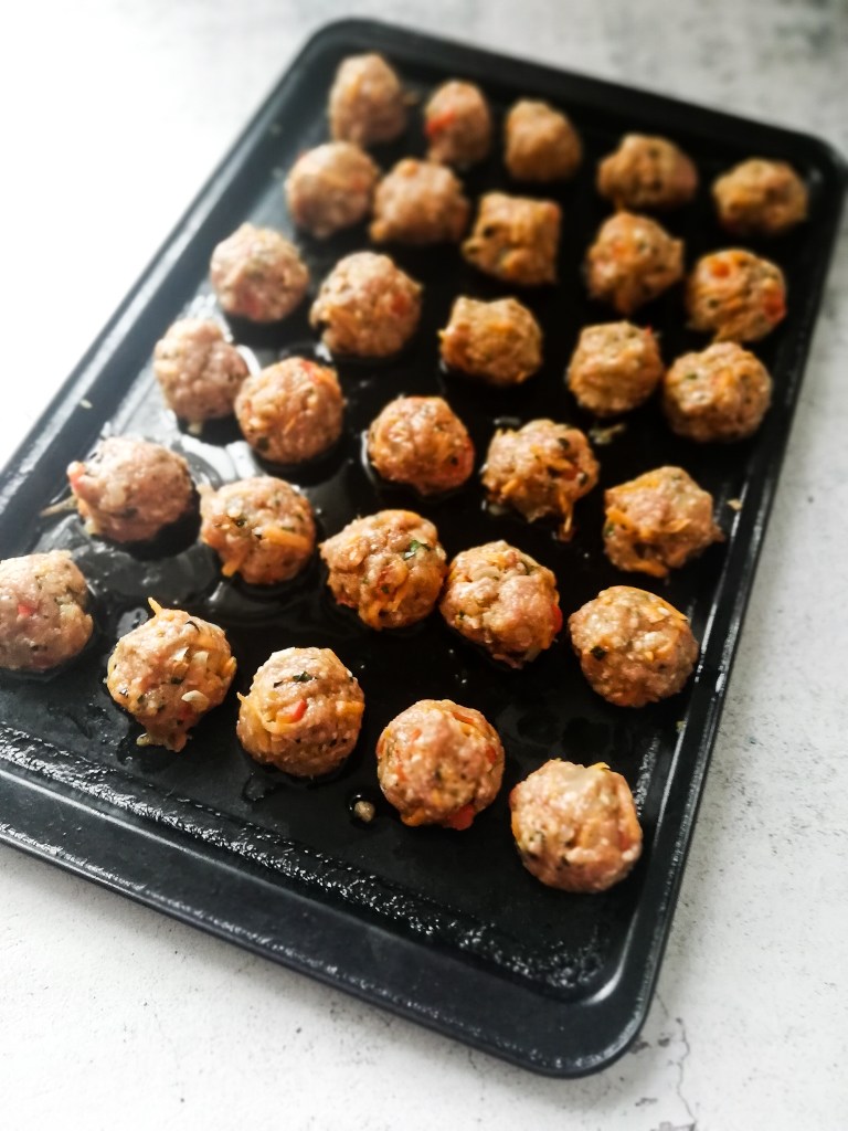 Image of Fragrant lamb meatballs on baking tray