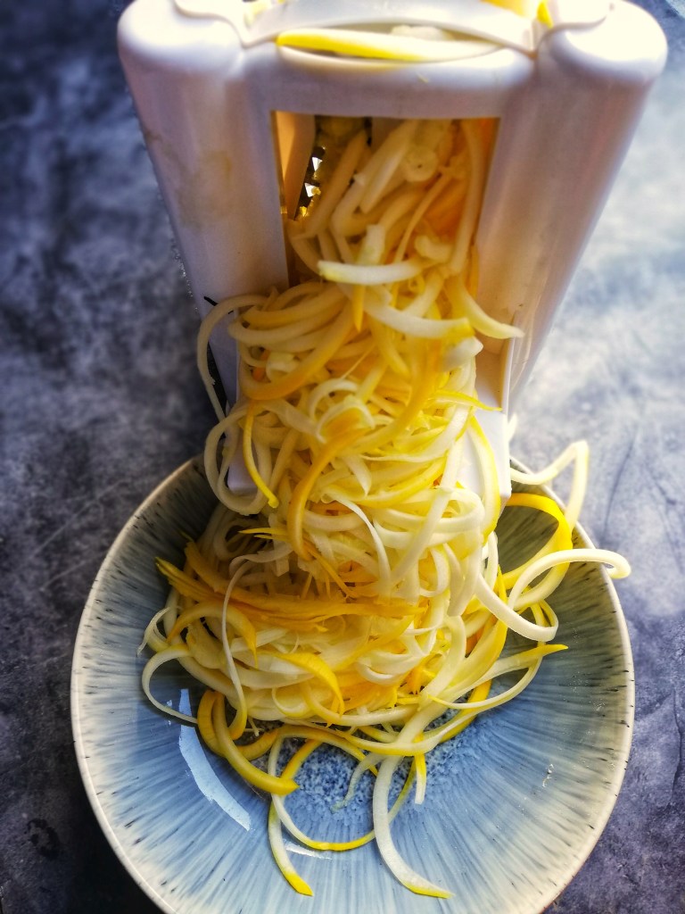 Image, bowl of Spiralized pattypan squash and Spiralizer.