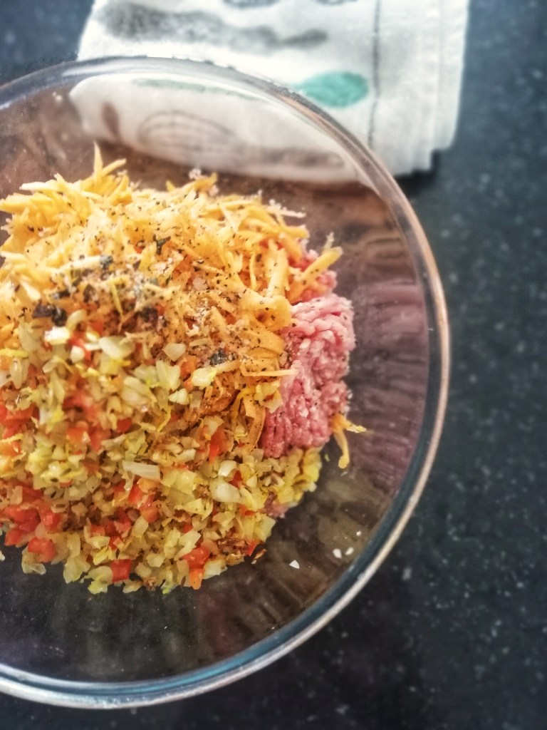 Image, Mixing the lamb ingredients, glass bowl on counter top