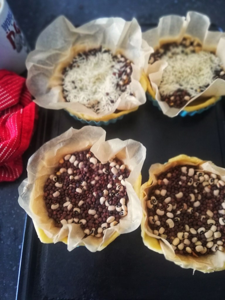 Image, Sweet tart shells filled with baking beans, ready for the oven.