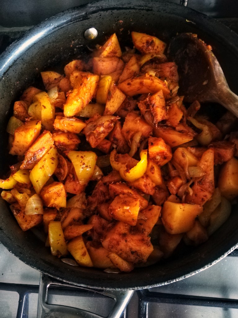 Sauteing the squash, onions peppers, garlic and spices, frying pan, stove top