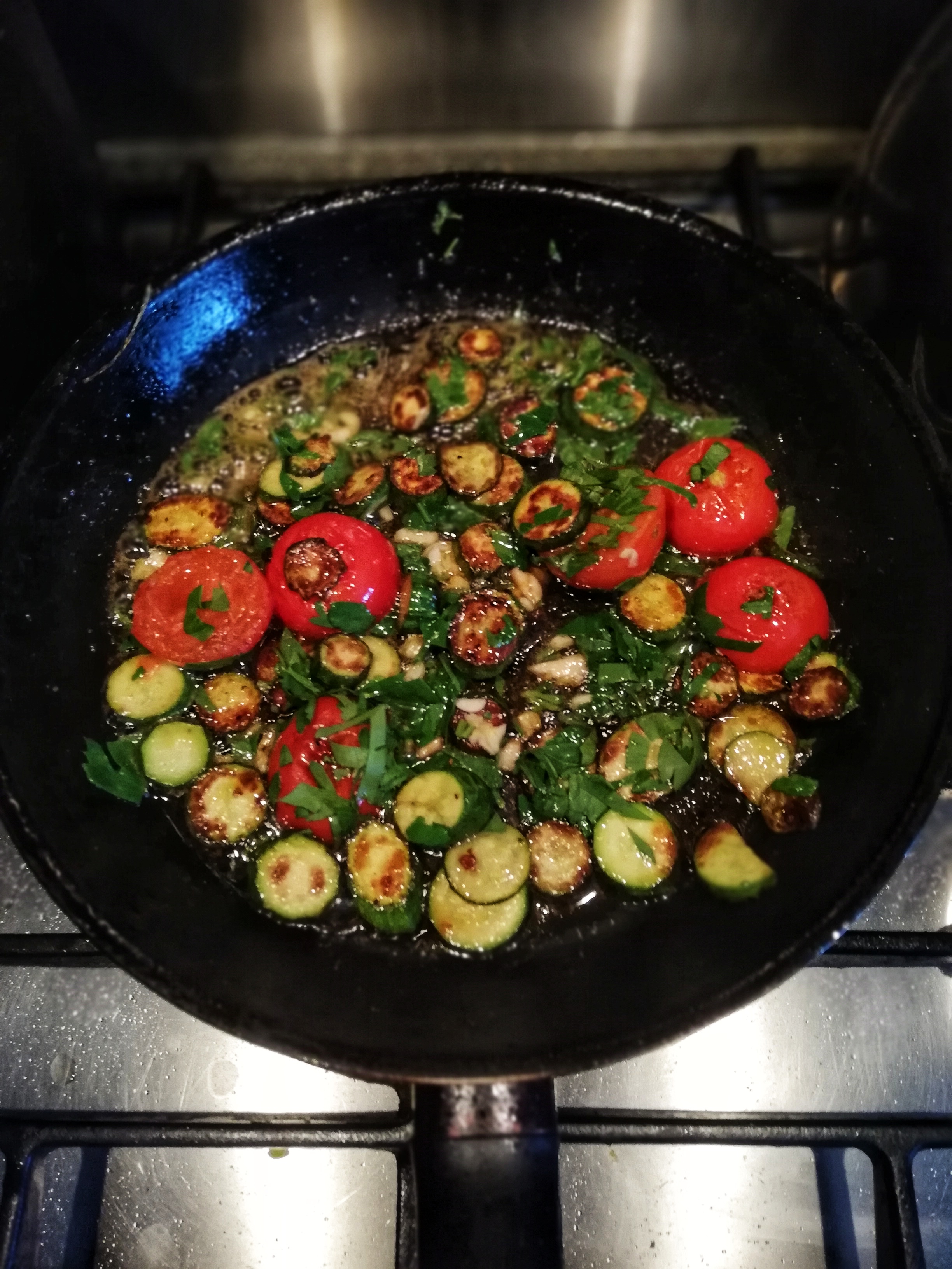 Finishing the baby courgettes, and tomato with garlic, parsley and lemon